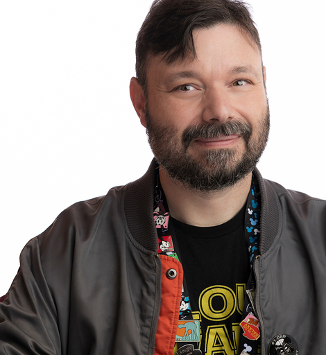 Will Kotheimer, smiling, in a grey bomber jacket