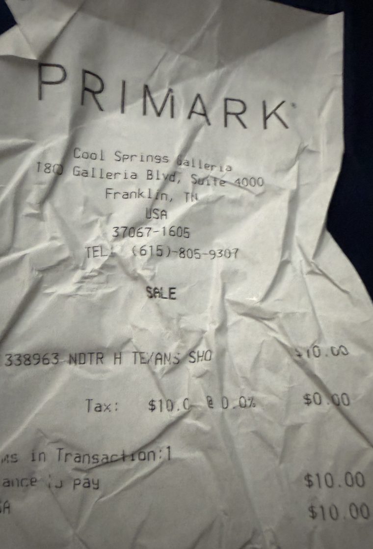 The Primark receipt: creased thermal paper on a dark surface, reading PRIMARK, Cool Springs Galleria, one item at $10.00 with $0.00 tax.